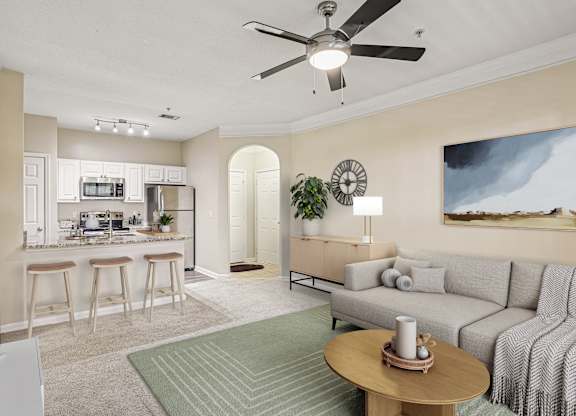 A living room with a grey couch and a wooden coffee table.