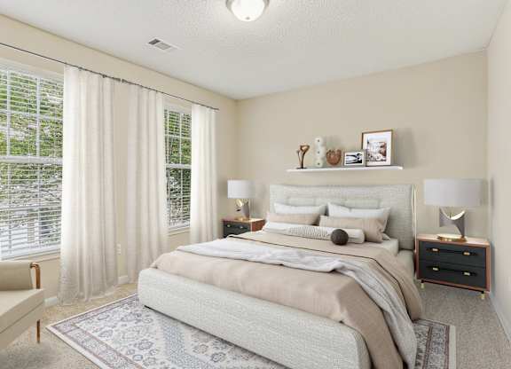 A bedroom with a large bed and a chair.