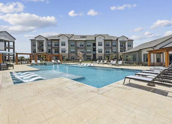 a swimming pool with lounge chairs and cabanas