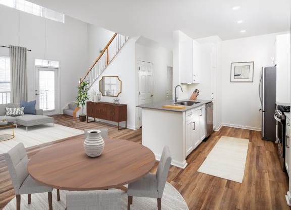 Furnished living and dining room with stairs and kitchen in background