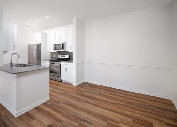 Vacant dining room with kitchen adjacent