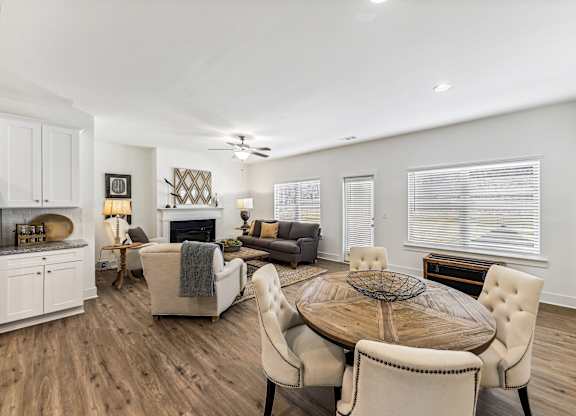a living room with a table and chairs and a fireplace