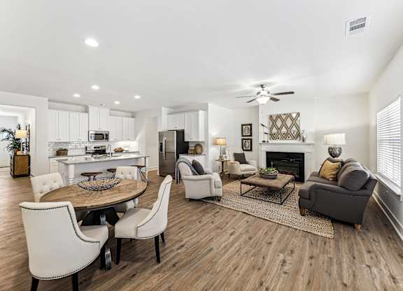 a living room with a table and chairs and a fireplace