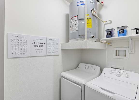 A laundry room with a washer and dryer and a laundry guide.