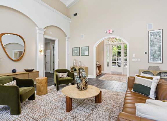 A living room with a green chair and a wooden coffee table.
