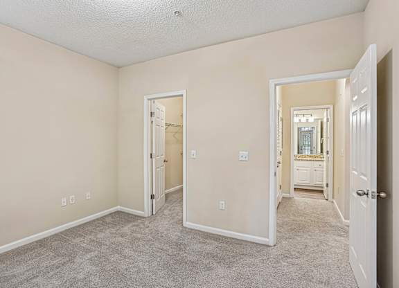 A room with a carpeted floor and white walls.