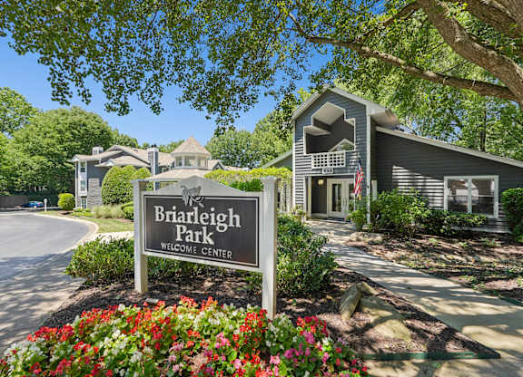 A sign that says Briarleigh Park Welcome Center in front of a building.
