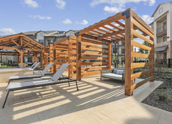 Poolside cabanas with lounge chairs and daybeds