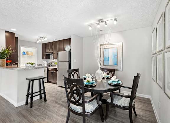 A dining room with a table set for four.