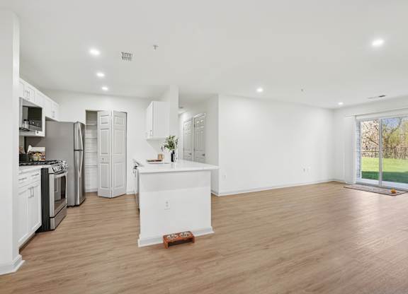 A kitchen with white appliances and cabinets is shown.