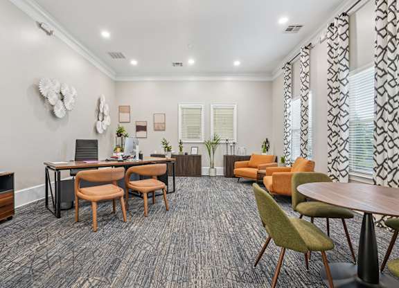 A modern living room with a grey carpet and wooden furniture.