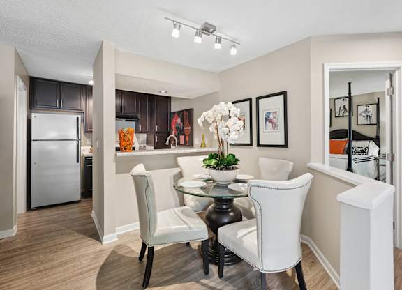 A modern kitchen with a dining table and chairs.