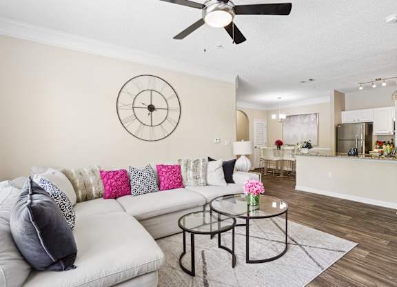 A living room with a white couch and a coffee table.