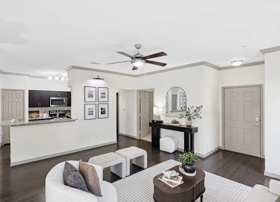 A modern living room with a white sofa and a coffee table.