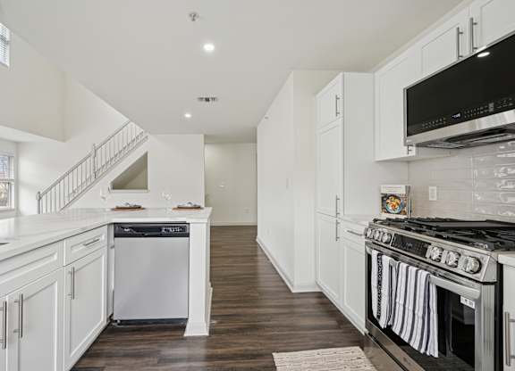 A white kitchen with a stove top oven.