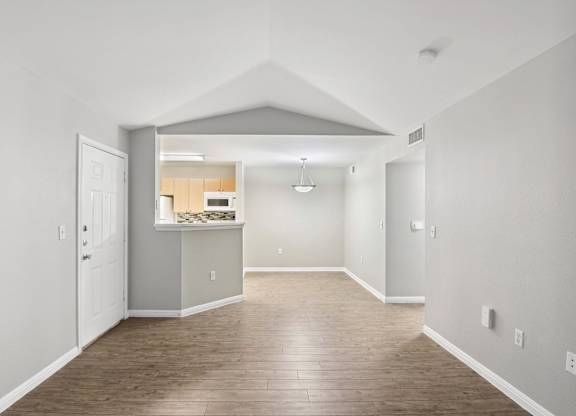 living room with vaulted ceiling and wood looking flooring