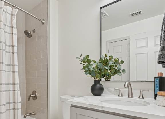 A white toilet sits next to a sink in a bathroom.
