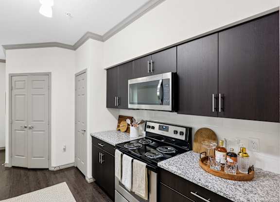 A kitchen with a stove top oven and a microwave.