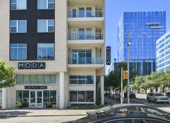 A street view of a building with the word "MODA" on it.