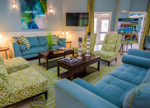 A living room with a blue couch and a coffee table.