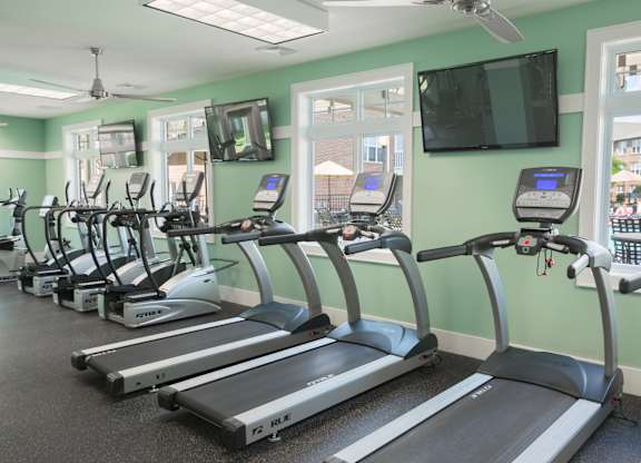 A gym with treadmills and exercise bikes.