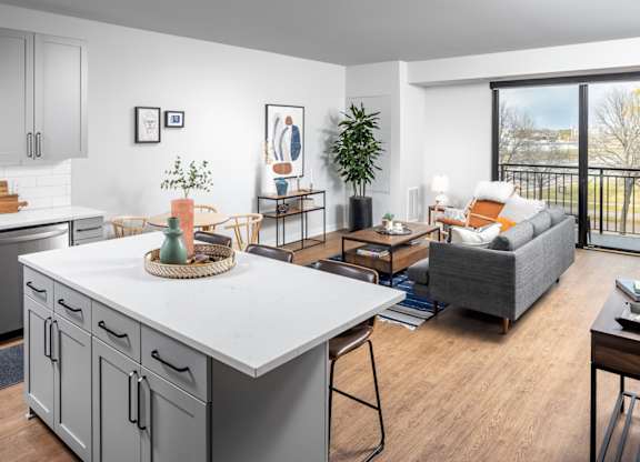 A modern kitchen with a dining table and chairs.