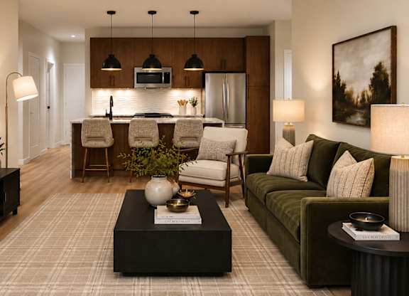 A modern living room with a dark wooden coffee table and a green sofa.