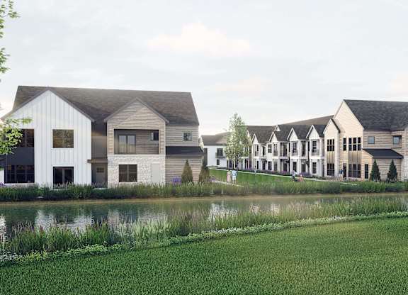 A row of houses with a body of water in front.