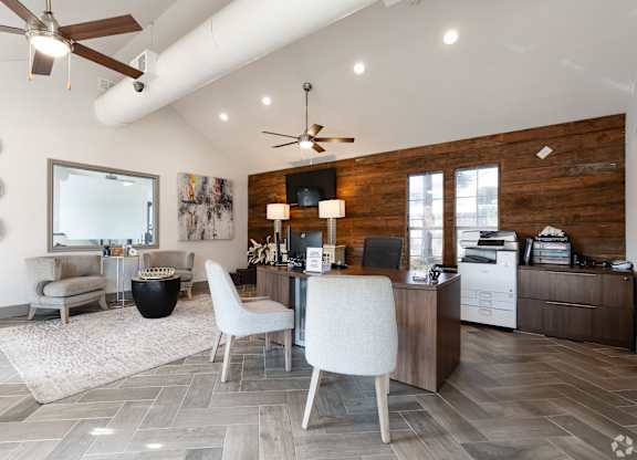 A modern home office with a white chair and a wooden desk.