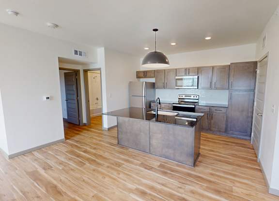 A kitchen with wooden floors and a modern design.