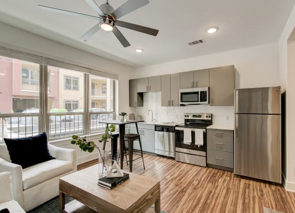 a kitchen with stainless steel appliances and a ceiling fan