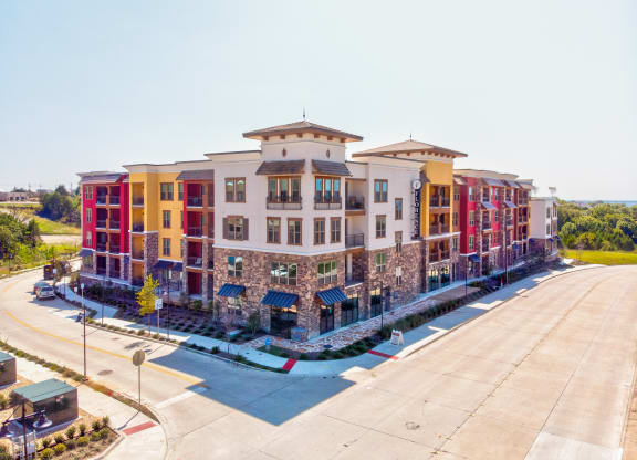 an aerial view of a large apartment complex with a parking lot in front of it