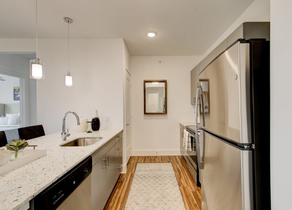 a kitchen with granite countertops and stainless steel appliances