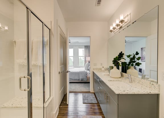 a bathroom with a glass shower stall