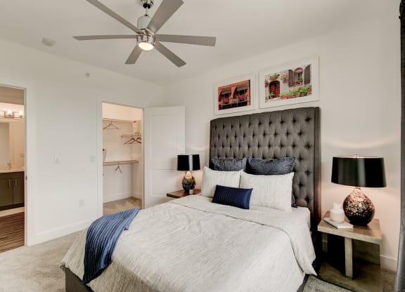 a bedroom with a bed and a ceiling fan