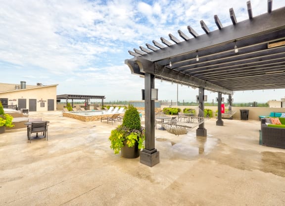 the patio has a pool and lounge area with chairs and tables