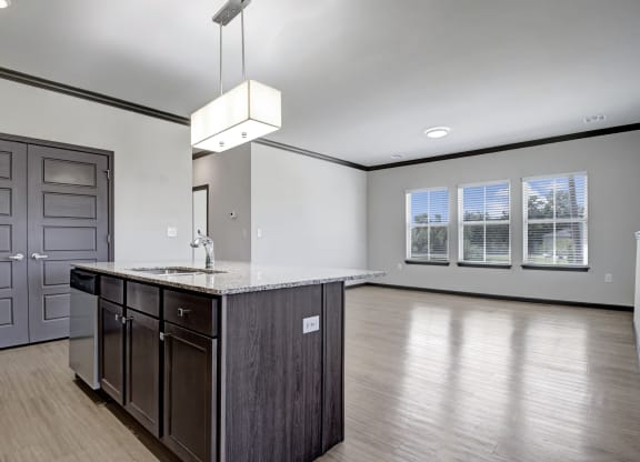an empty kitchen and living room with a counter top