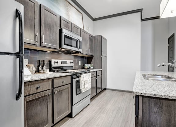 a kitchen with stainless steel appliances and wooden cabinets