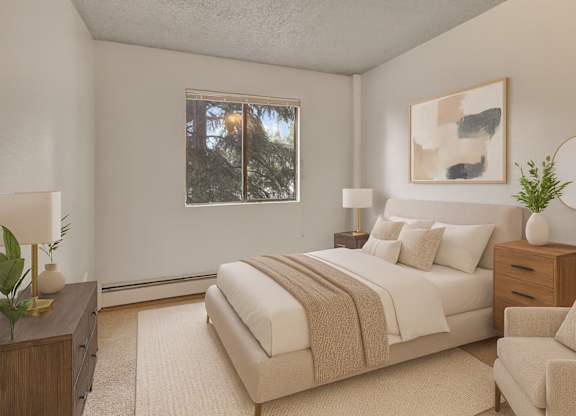 A cozy bedroom here at Deer Park featuring a neutral-toned upholstered bed with white bedding and a soft taupe throw, matching wood nightstands with lamps, modern abstract wall art, plush carpeting, and a window providing natural light for a calm, comfortable retreat.