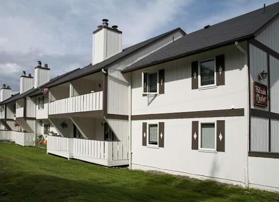 A white building with a sign that  says