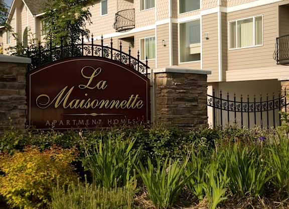 A sign that says La Maisomette in front of apartment building.