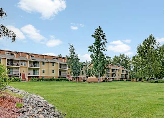 Apartment complex with a green lawn in front.