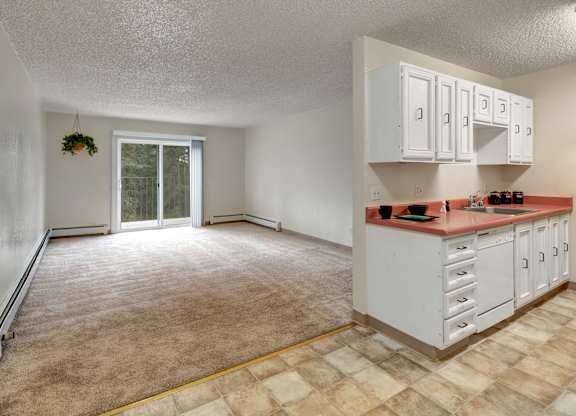 A kitchen with white cabinets and a countertop.