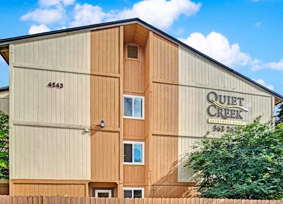 The Quiet Creek building has a brown and tan exterior.
