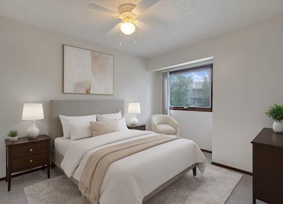 A bedroom with a bed, two lamps, a painting, and a window.