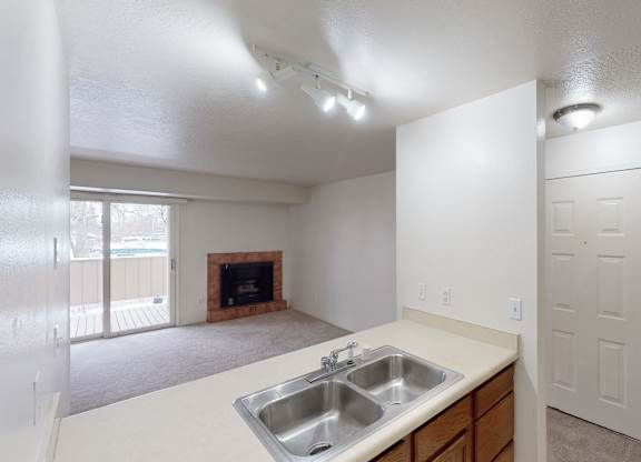 A kitchen with a sink and a fireplace.