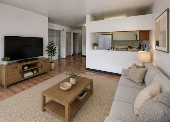 A modern living room with a grey sofa and a wooden coffee table.