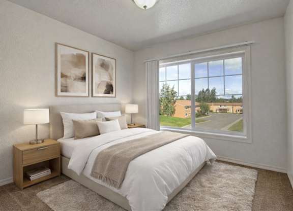 Bright bedroom here at The Glen featuring a neatly made bed with white bedding and neutral throw blanket, matching nightstands with lamps, soft carpet flooring, and a large window that brings in natural light and views of the community grounds.