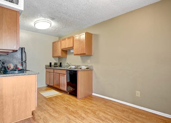 an empty kitchen with wooden cabinets and a counter top