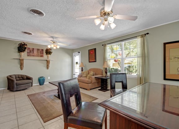 a dining room and living room with a table and chairs